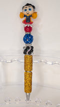 Decorative pen with a Doctor Strange doorable top on a white surface