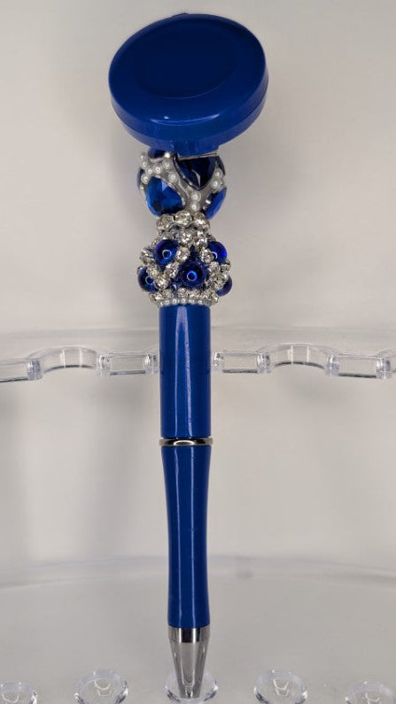 Blue decorative pen on a clear stand with a white background